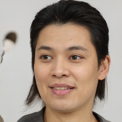 Joyful asian young-adult female with medium  brown hair and brown eyes