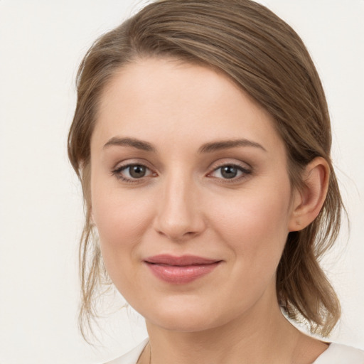 Joyful white young-adult female with medium  brown hair and grey eyes