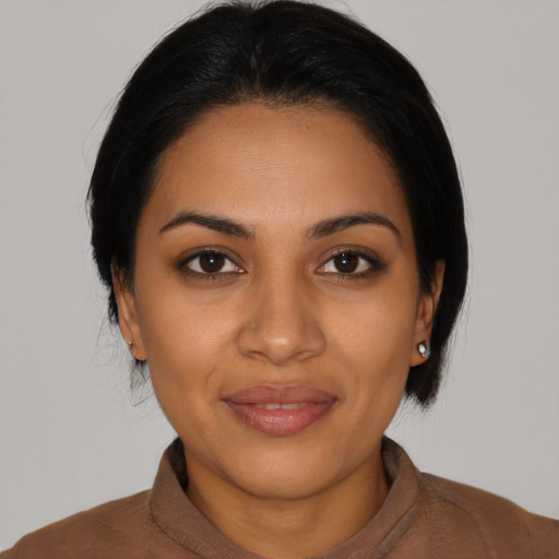 Joyful latino young-adult female with medium  black hair and brown eyes