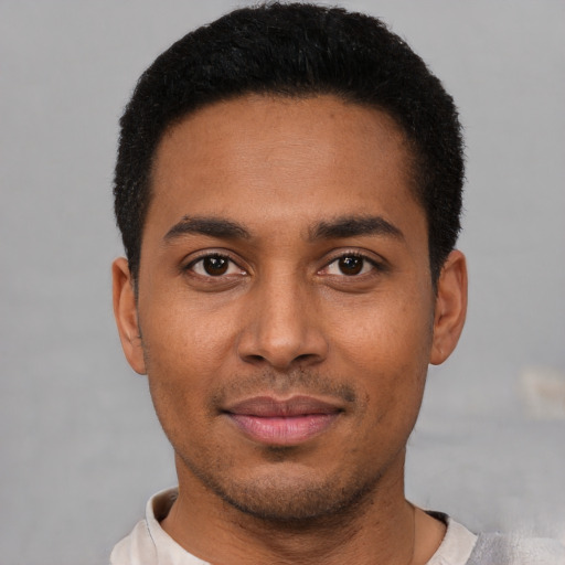 Joyful latino young-adult male with short  black hair and brown eyes