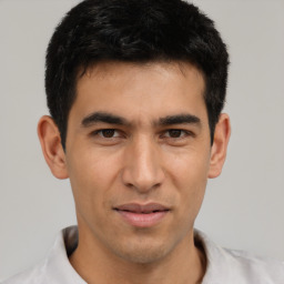 Joyful asian young-adult male with short  black hair and brown eyes