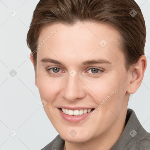 Joyful white young-adult female with short  brown hair and grey eyes