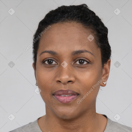 Joyful black adult female with short  black hair and brown eyes