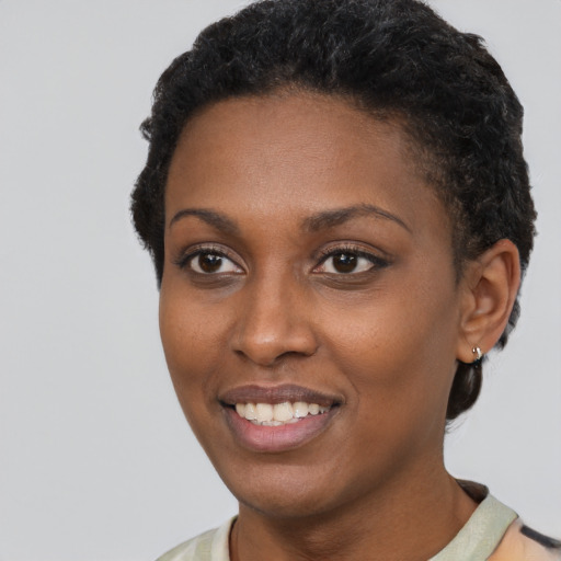 Joyful latino young-adult female with short  black hair and brown eyes