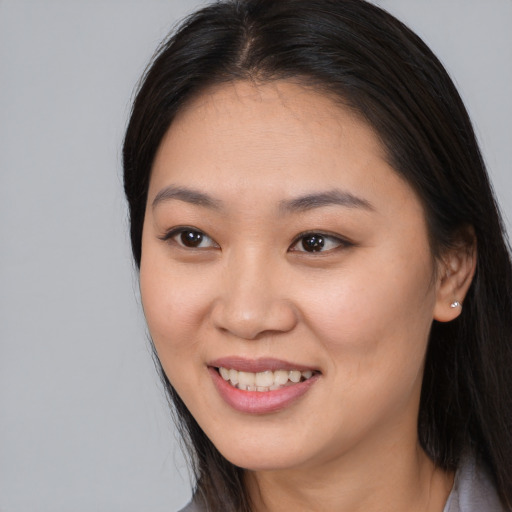 Joyful asian young-adult female with long  brown hair and brown eyes