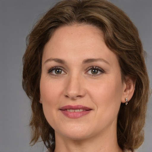 Joyful white adult female with medium  brown hair and grey eyes