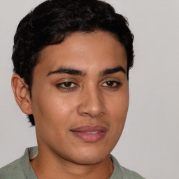 Joyful latino young-adult male with short  brown hair and brown eyes