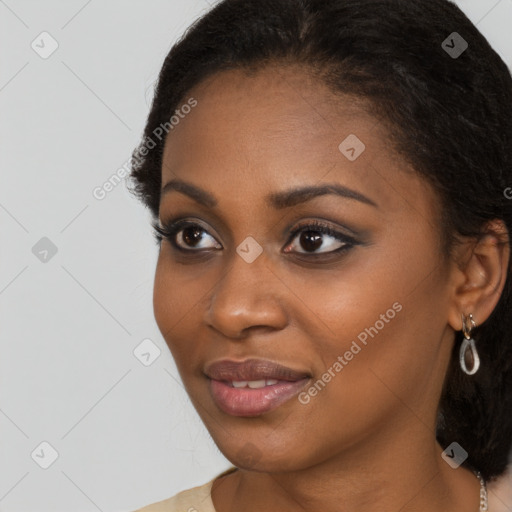 Joyful black young-adult female with long  black hair and brown eyes