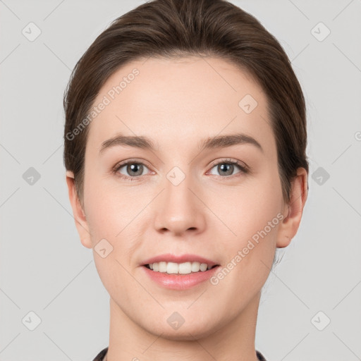 Joyful white young-adult female with short  brown hair and grey eyes