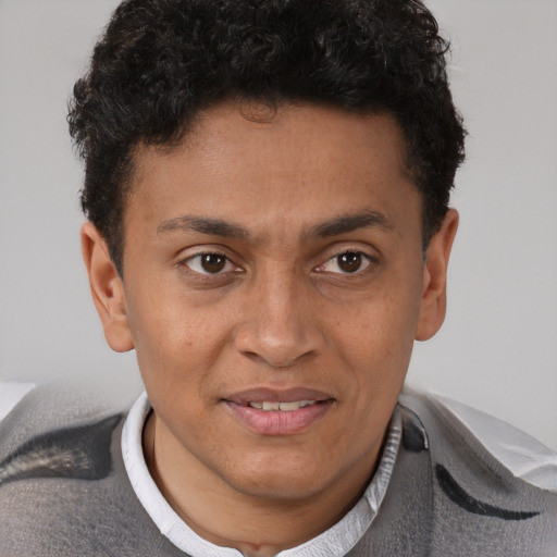 Joyful latino young-adult male with short  brown hair and brown eyes