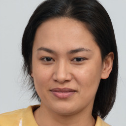 Joyful asian young-adult female with medium  brown hair and brown eyes