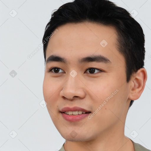 Joyful asian young-adult male with short  black hair and brown eyes