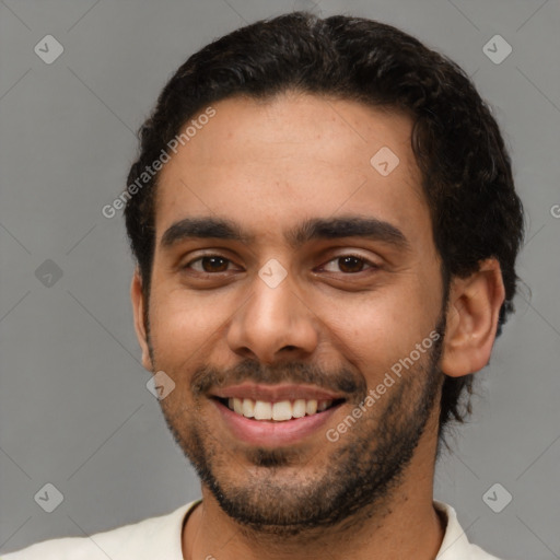 Joyful latino young-adult male with short  black hair and brown eyes