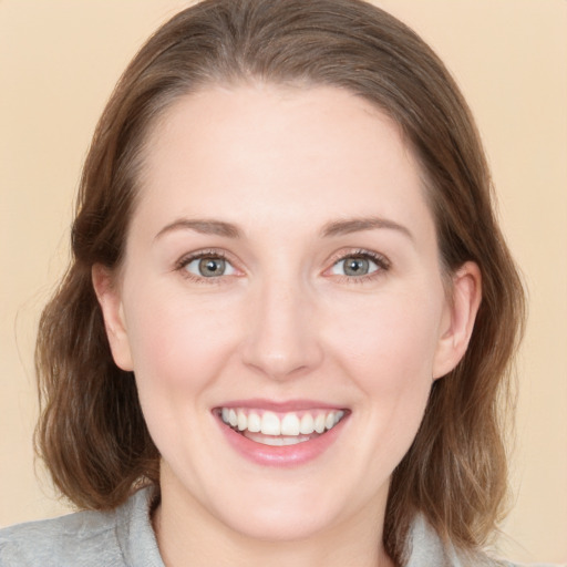 Joyful white young-adult female with medium  brown hair and grey eyes