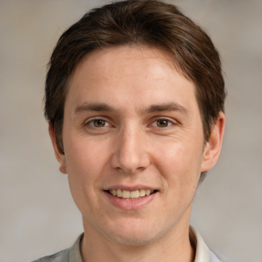 Joyful white adult male with short  brown hair and grey eyes