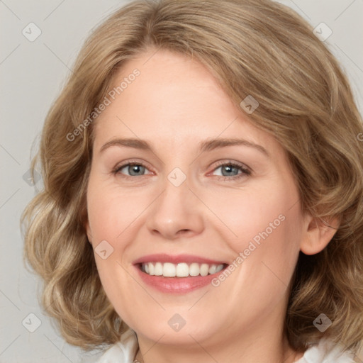 Joyful white young-adult female with medium  brown hair and blue eyes