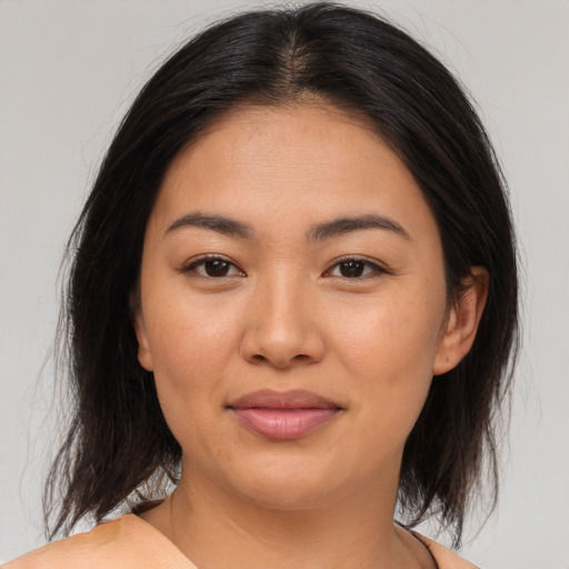 Joyful asian young-adult female with medium  brown hair and brown eyes