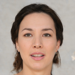 Joyful white young-adult female with medium  brown hair and brown eyes