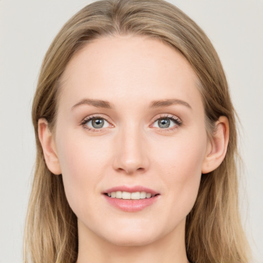 Joyful white young-adult female with long  brown hair and blue eyes