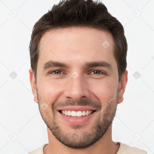 Joyful white young-adult male with short  brown hair and brown eyes