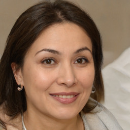 Joyful white adult female with medium  brown hair and brown eyes