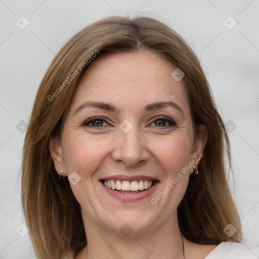 Joyful white adult female with medium  brown hair and grey eyes