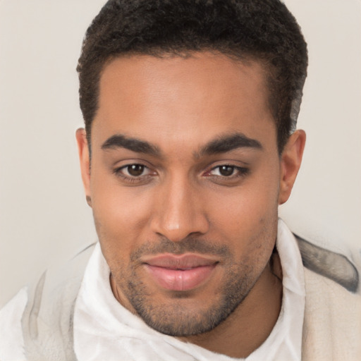 Joyful latino young-adult male with short  brown hair and brown eyes