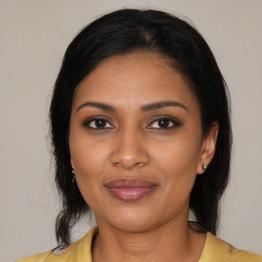 Joyful black young-adult female with medium  black hair and brown eyes