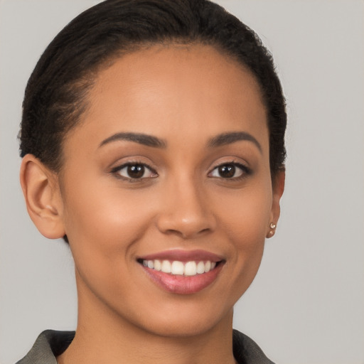 Joyful latino young-adult female with short  brown hair and brown eyes