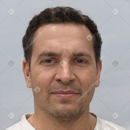 Joyful white adult male with short  brown hair and brown eyes