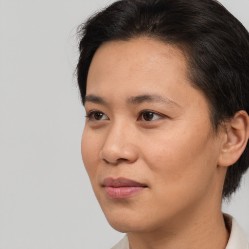 Joyful white young-adult female with short  black hair and brown eyes