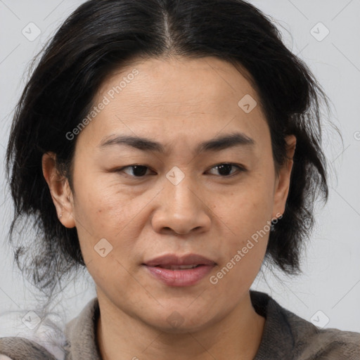 Joyful latino adult female with medium  brown hair and brown eyes