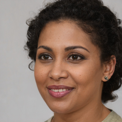 Joyful black young-adult female with medium  brown hair and brown eyes