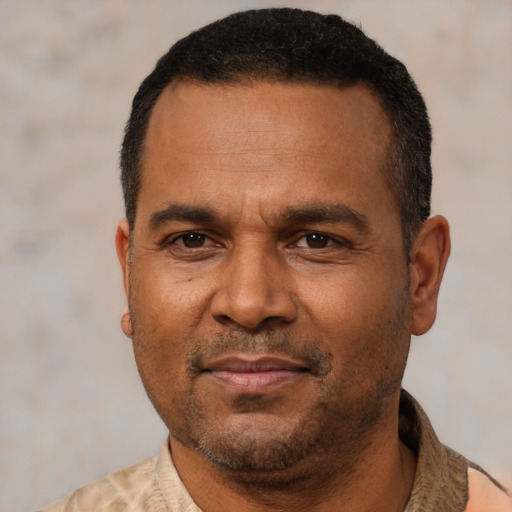 Joyful latino adult male with short  black hair and brown eyes