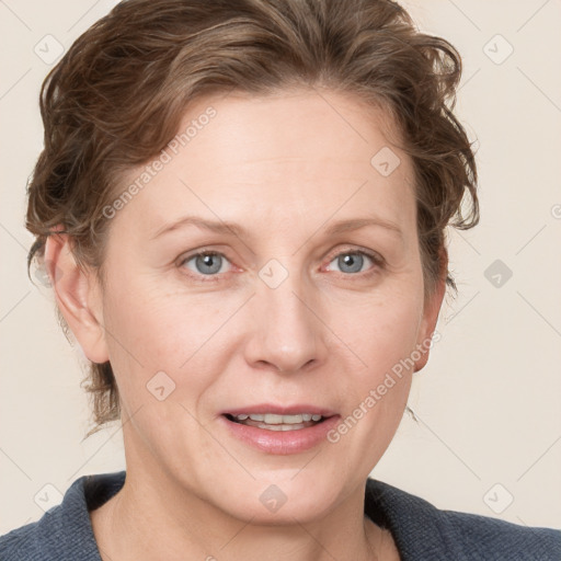 Joyful white adult female with medium  brown hair and blue eyes