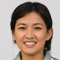 Joyful asian young-adult female with medium  brown hair and brown eyes