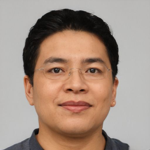 Joyful asian young-adult male with short  black hair and brown eyes
