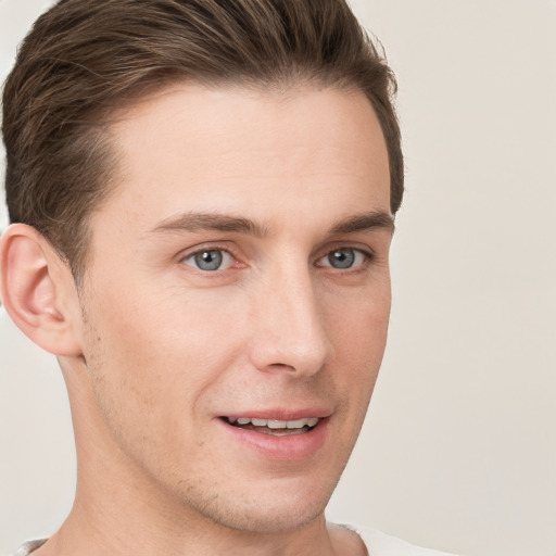 Joyful white young-adult male with short  brown hair and grey eyes