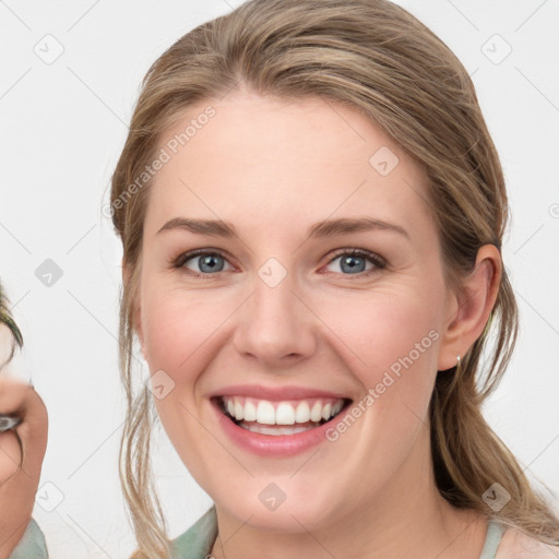 Joyful white young-adult female with medium  brown hair and blue eyes