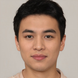 Joyful asian young-adult male with short  black hair and brown eyes