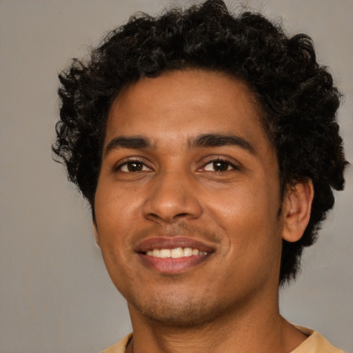 Joyful black young-adult male with short  black hair and brown eyes