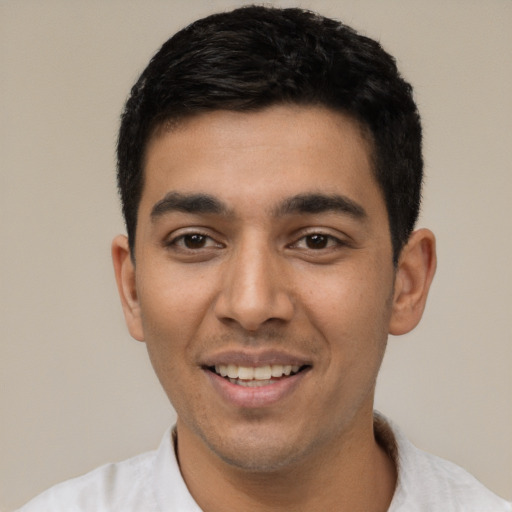 Joyful latino young-adult male with short  black hair and brown eyes