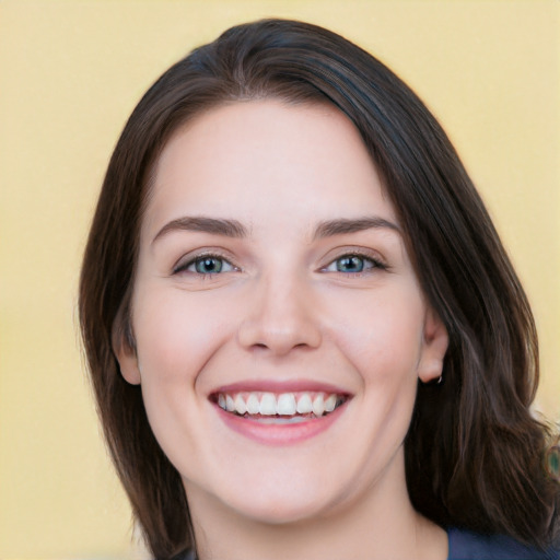 Joyful white young-adult female with medium  brown hair and green eyes