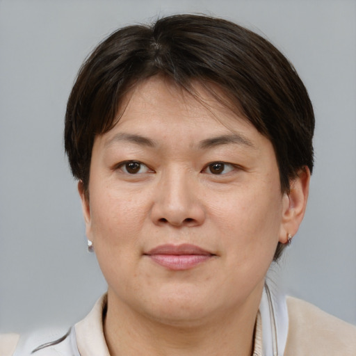Joyful asian adult female with short  brown hair and brown eyes