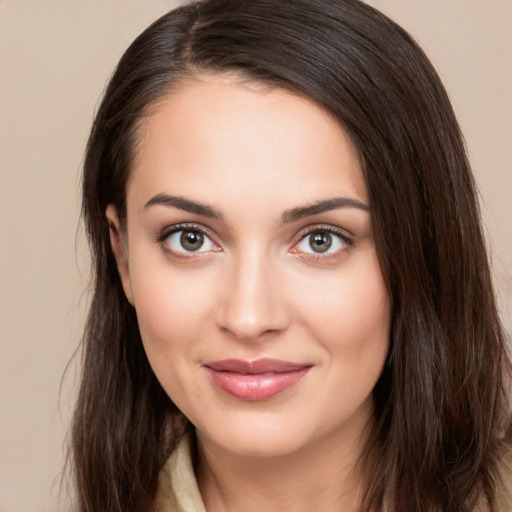 Joyful white young-adult female with long  brown hair and brown eyes