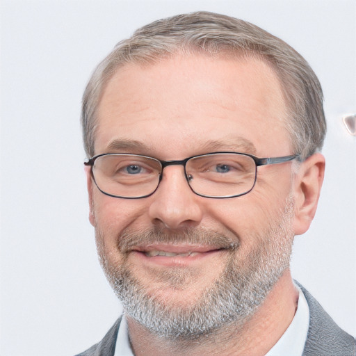 Joyful white middle-aged male with short  gray hair and blue eyes