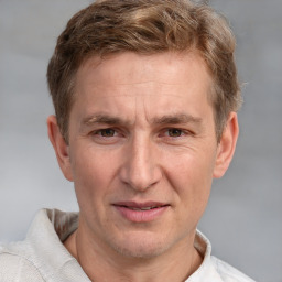 Joyful white adult male with short  brown hair and grey eyes