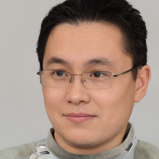 Joyful asian young-adult male with short  brown hair and brown eyes