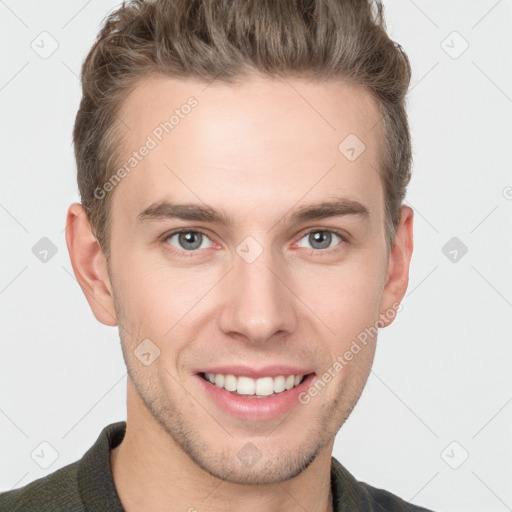 Joyful white young-adult male with short  brown hair and grey eyes