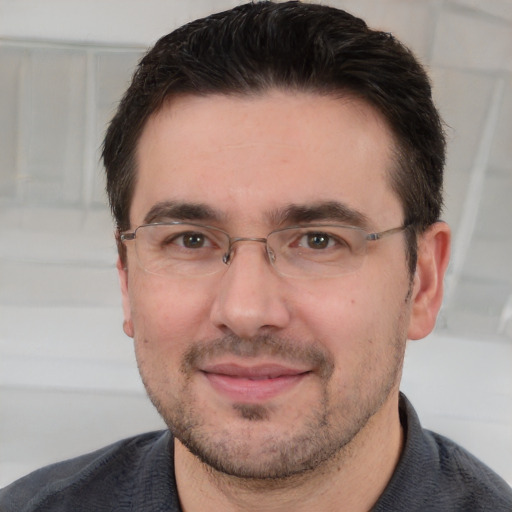 Joyful white adult male with short  brown hair and brown eyes